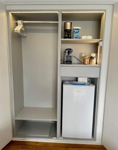 a white refrigerator with its door open in a kitchen at Acropolis Museum Apartment in Athens