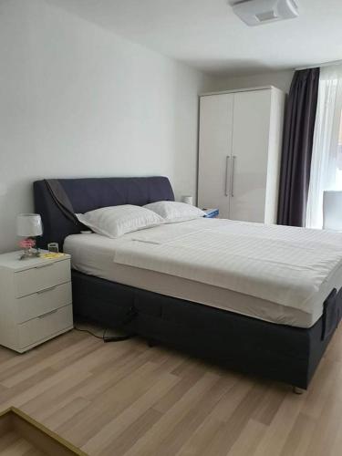 a bedroom with a large bed with a night stand at Aldi 2 in Pula
