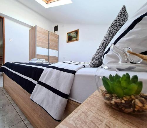 sypialnia z łóżkiem i stołem z rośliną w obiekcie Apartments Ana Medulin w Medulinie