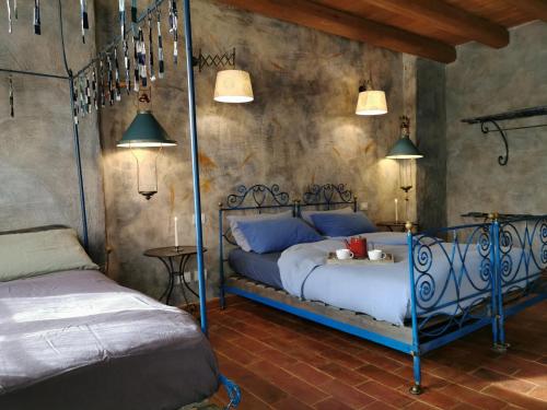 a bedroom with a bed with a blue metal frame at Oasi Galbusera Bianca in Rovagnate