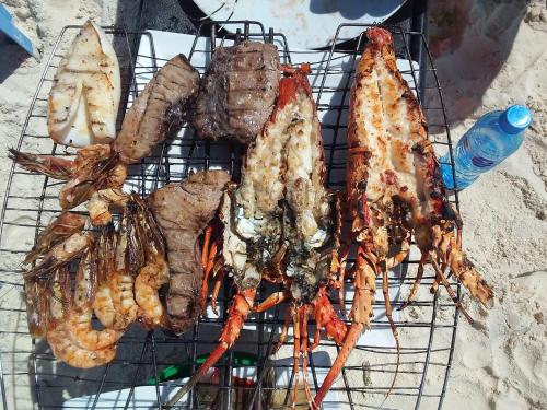 a grill with a bunch of food on it at COCO REEF ECOLODGE in Kizimkazi