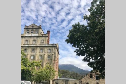 a building with a clock tower on top of it at Sub Penthouse Luxe suit, CBD, secure parking, in Hobart