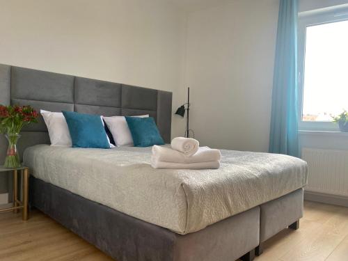 a bedroom with a large bed with two towels on it at Apartament Camilli Lackberg in Jelenia Góra