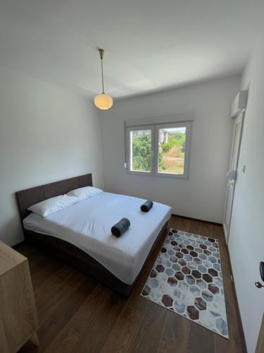 a bedroom with a bed and a window at Entire 1-bedroom apartment with free parking in Podgorica