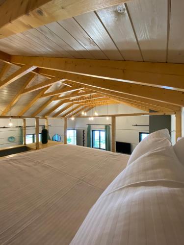 a bedroom with a large bed in a room with wooden ceilings at Ktima Papadimitriou in Ioannina