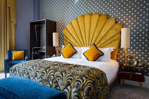 a bedroom with a large bed with a large yellow headboard at Number 31 in Dublin