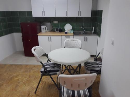 - une cuisine avec une table, des chaises et un évier dans l'établissement Apartman Sara, à Sarajevo