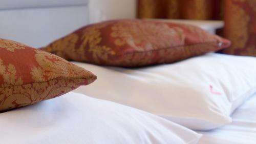 two pillows sitting on top of a bed at Wrzos & Belvedere in Kudowa-Zdrój