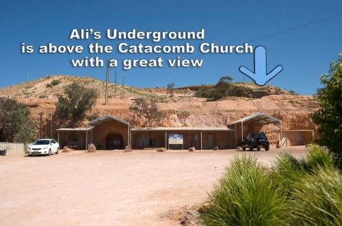 a picture of a building with a mountain in the background at Ali's Underground Studio in Coober Pedy