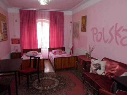 un soggiorno con 2 letti e un divano di Dom Polski a Gyumri