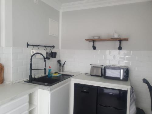 a kitchen with a sink and a microwave at R&S Apartments Bremen in Bremen