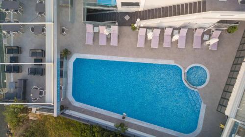 an overhead view of a swimming pool in a building at Denise Beach Hotel in Laganas