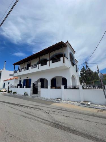 a white building on the side of a street at GIALOS APARTMENT in Elafonisos