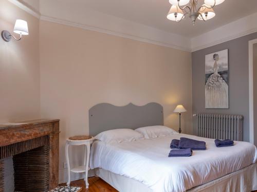 a bedroom with a bed with blue towels on it at La Villa François Premier in La Bourboule