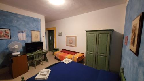 a room with a bedroom with a bed and a desk at B&B da Donatella in Santa Maria