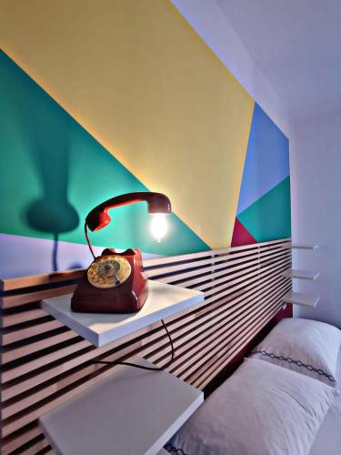a bed with a desk with a lamp and a laptop at Bed and Breakfast il Pesciolino in Trani