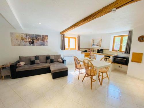 a living room with a couch and a table at Résidence Saint-Jean in Saint-Dalmas-le-Selvage