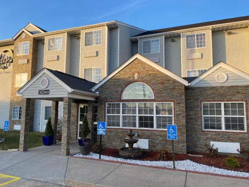 a house with two blue parking signs in front of it at Sleep Inn St Robert-Fort Leonard Wood in Saint Robert