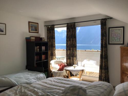 a bedroom with a window with a view of the ocean at Iris Vedal in Nauste