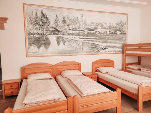 two beds in a room with a painting on the wall at Apartment Beganovic-Centar in Kulen Vakuf