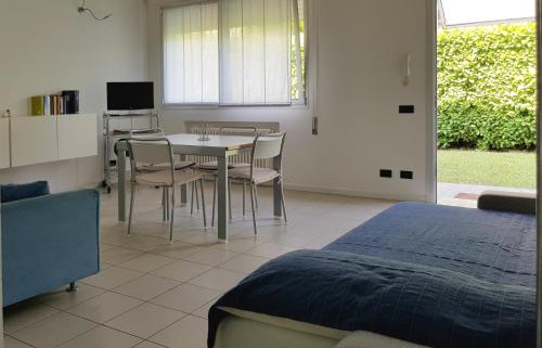 a bedroom with a bed and a table and chairs at Casa Nicky in Abano Terme