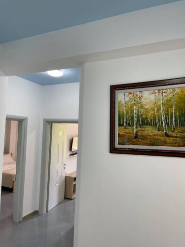 a painting on a wall in a room at The White Villa in Bogovë