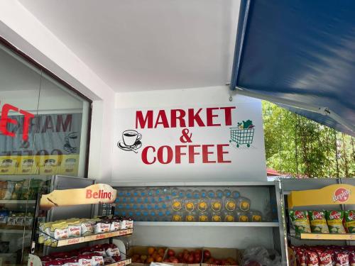 a market and coffee sign in a store at The White Villa in Bogovë