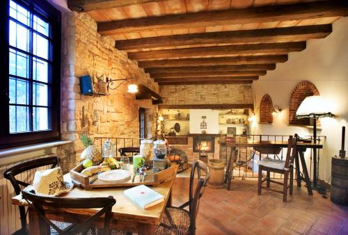 a living room with a wooden table and chairs at B&B Relais Cascina al Campaccio in Taino