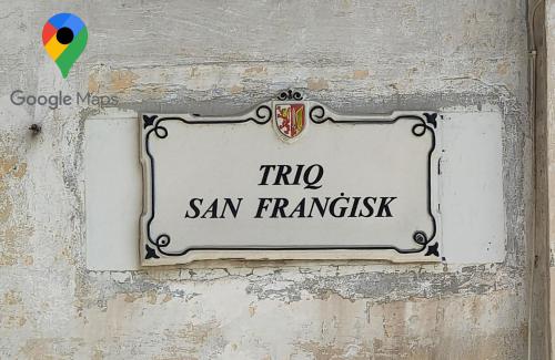 a sign on a wall with the words trip san francisco at Valletta Door in Il-Furjana