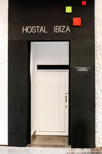 a white door in front of a building at Hostal Ibiza in Ibiza Town