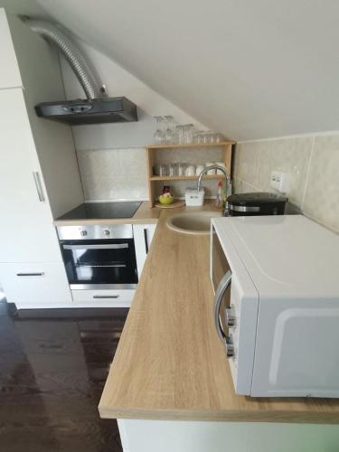 a kitchen with a sink and a counter top at New apartment near Plitvice lakes in Smoljanac