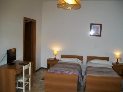 מיטה או מיטות בחדר ב-Locanda La Rotonda