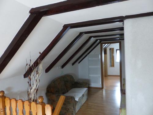 a living room with a couch and a staircase at House Pox in Plitvička Jezera