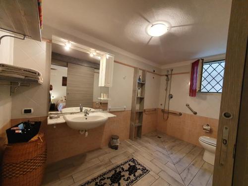 a bathroom with a sink and a toilet at VILLA SABA in Olbia