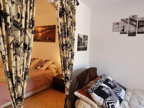 a bedroom with a bed and a curtain in a room at VILLA SABA in Olbia