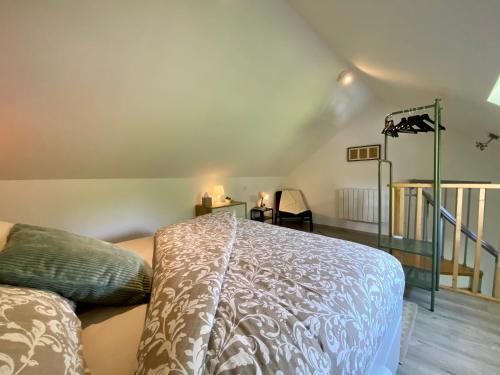 a bedroom with a bed and a staircase at Jiwe in Chilleurs-aux-Bois