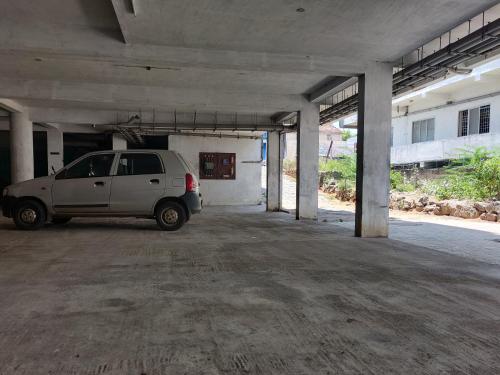 a white van parked in an empty parking garage at Hotel Sun Park in Kanyakumari