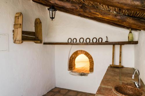 a kitchen with an oven in the wall at Cortijo Cabrilla in Periana