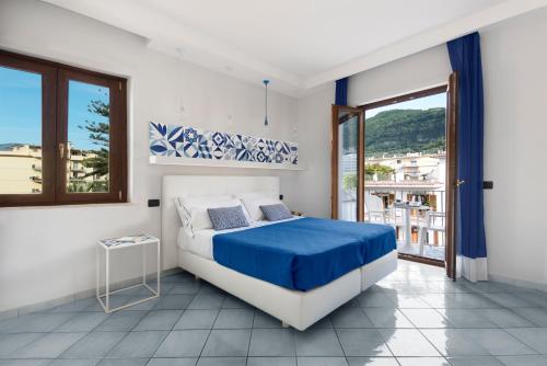 a bedroom with a bed and a large window at Hotel Leone in Sorrento