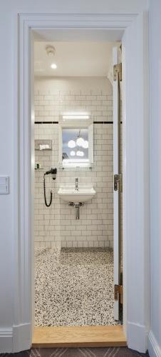 a bathroom with a sink and a window at Hotel Randers in Randers