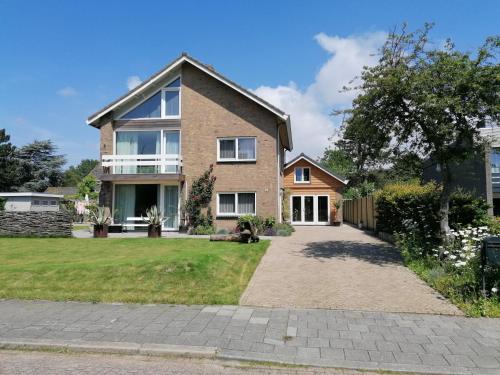 a large brick house with a driveway at Park aan Zee in Vlissingen