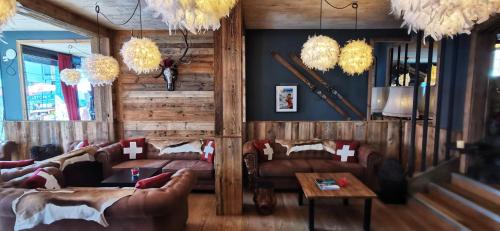 
a living room filled with furniture and a fire place at Hotel Bergidyll in Andermatt
