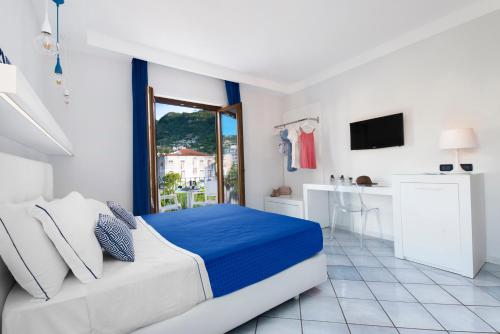 a bedroom with a bed and a window at Hotel Leone in Sorrento