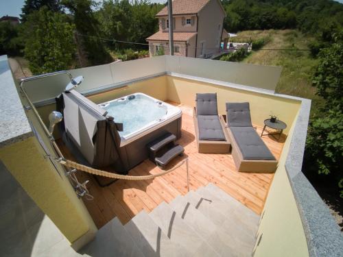 a hot tub on the roof of a house at Holiday house Toš-Vila with heated pool in Vrbnik