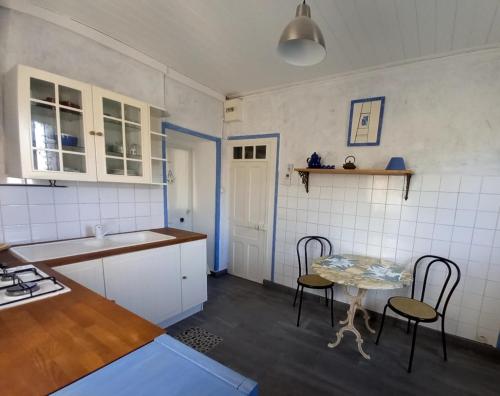 uma cozinha com mesa e cadeiras num quarto em Chez Chris em Jard-sur-Mer