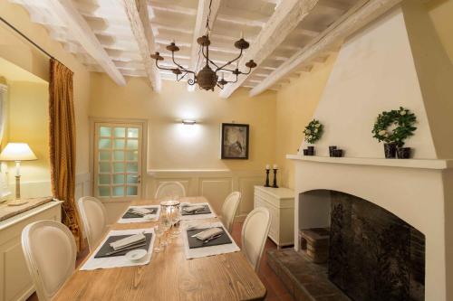 a dining room with a table and a fireplace at Locanda I Girasoli in Misano Adriatico