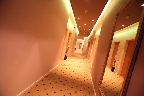 a hallway with a mirror and a long corridor at Hotel Gallus in Sesvete