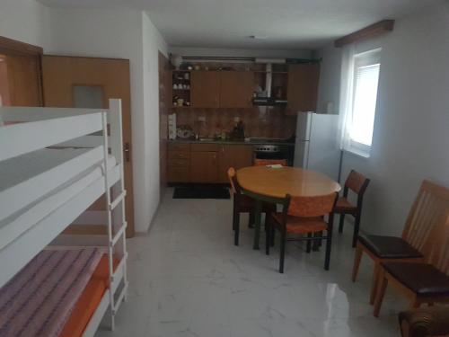 a kitchen with a table and chairs in a room at Apartman Nadija in Jajce