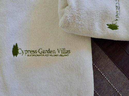 a white towel with a green logo on it at Cypress Garden Villas in Svoronata