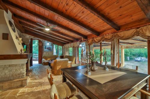 a living room with a dining table and a fireplace at Royal Villa Ana in Cetinje